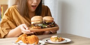 Woman Holding A Tray With Two Burgers